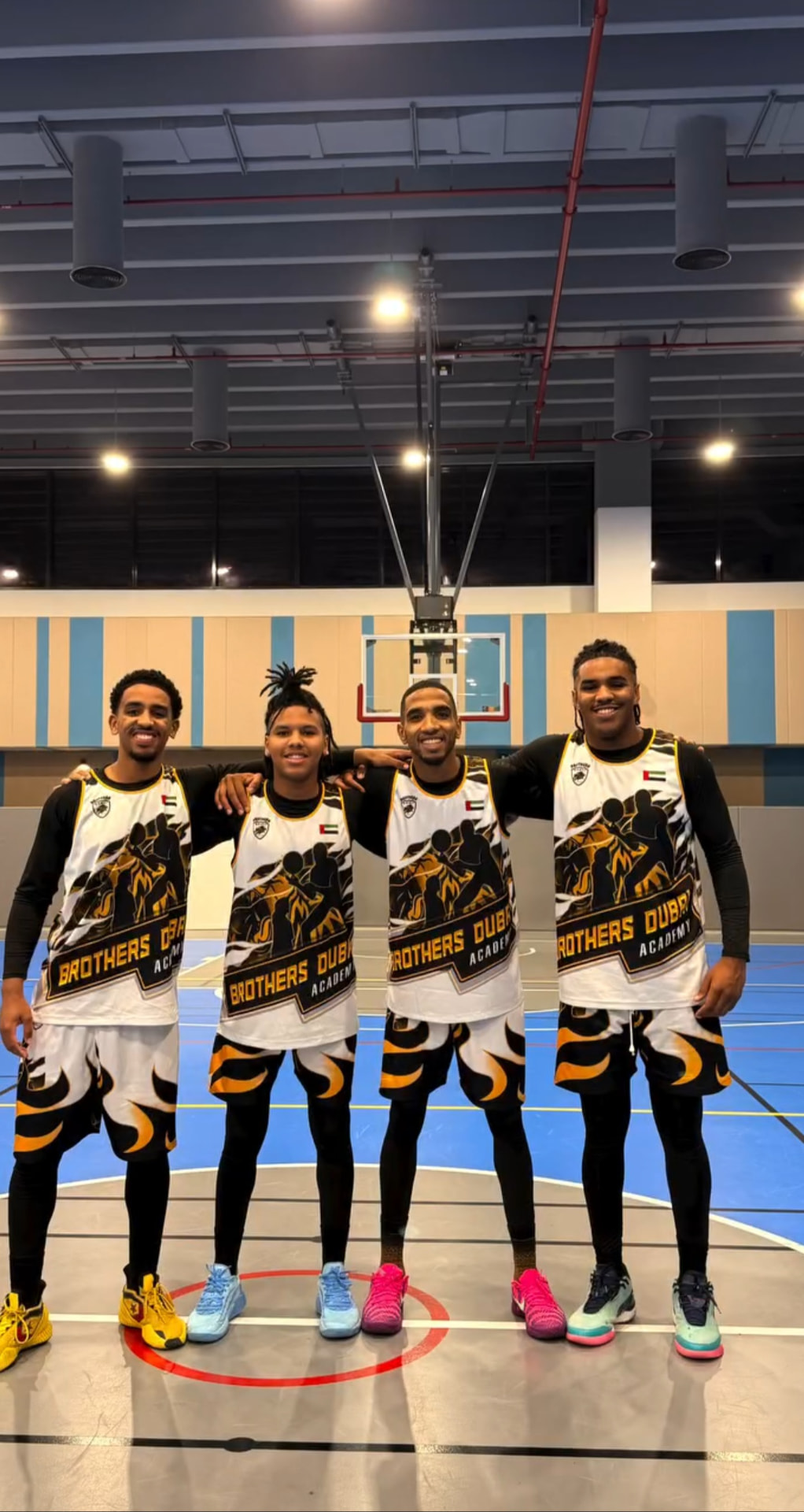 Brothers Dubai Academy coaches smiling together on court